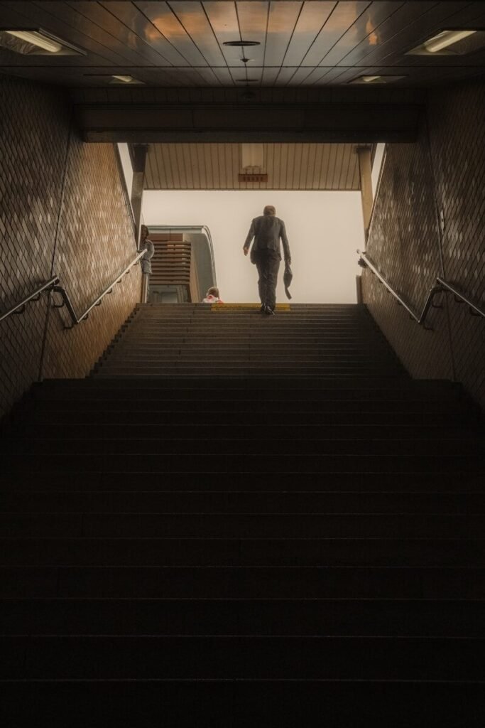 Man walks up stairs into bright light